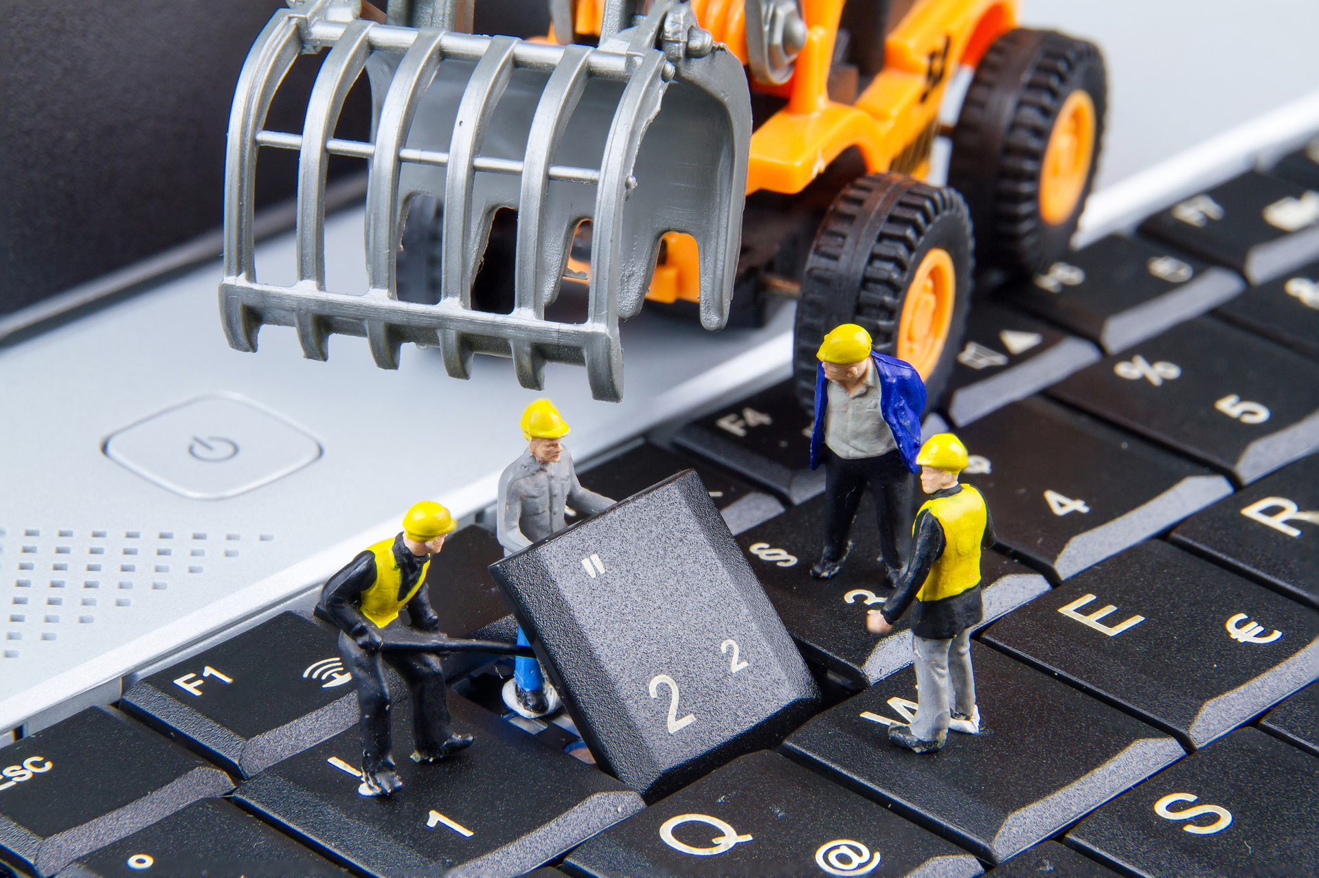 Repairing laptop with little workmen funny picture