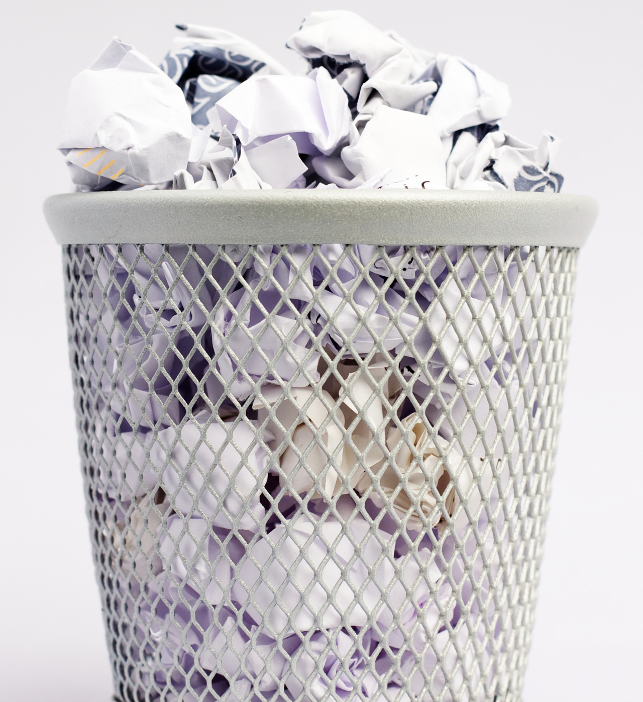 Wastepaper basket filled with paper